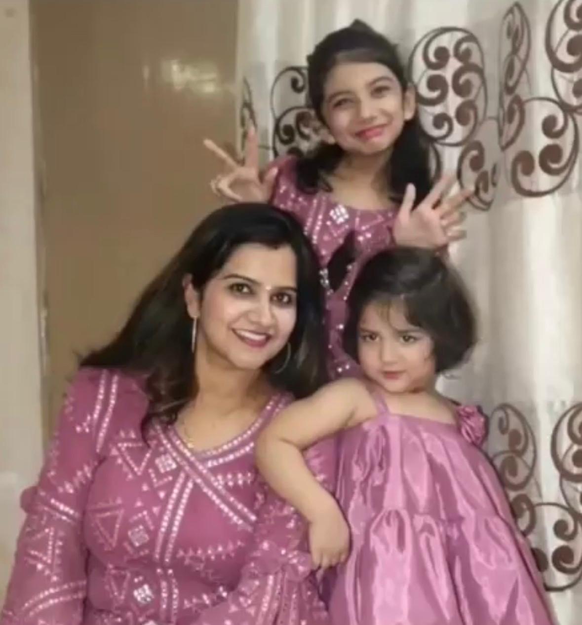 candid portrait of a child in high fashion urban attire standing in front of an architectural background